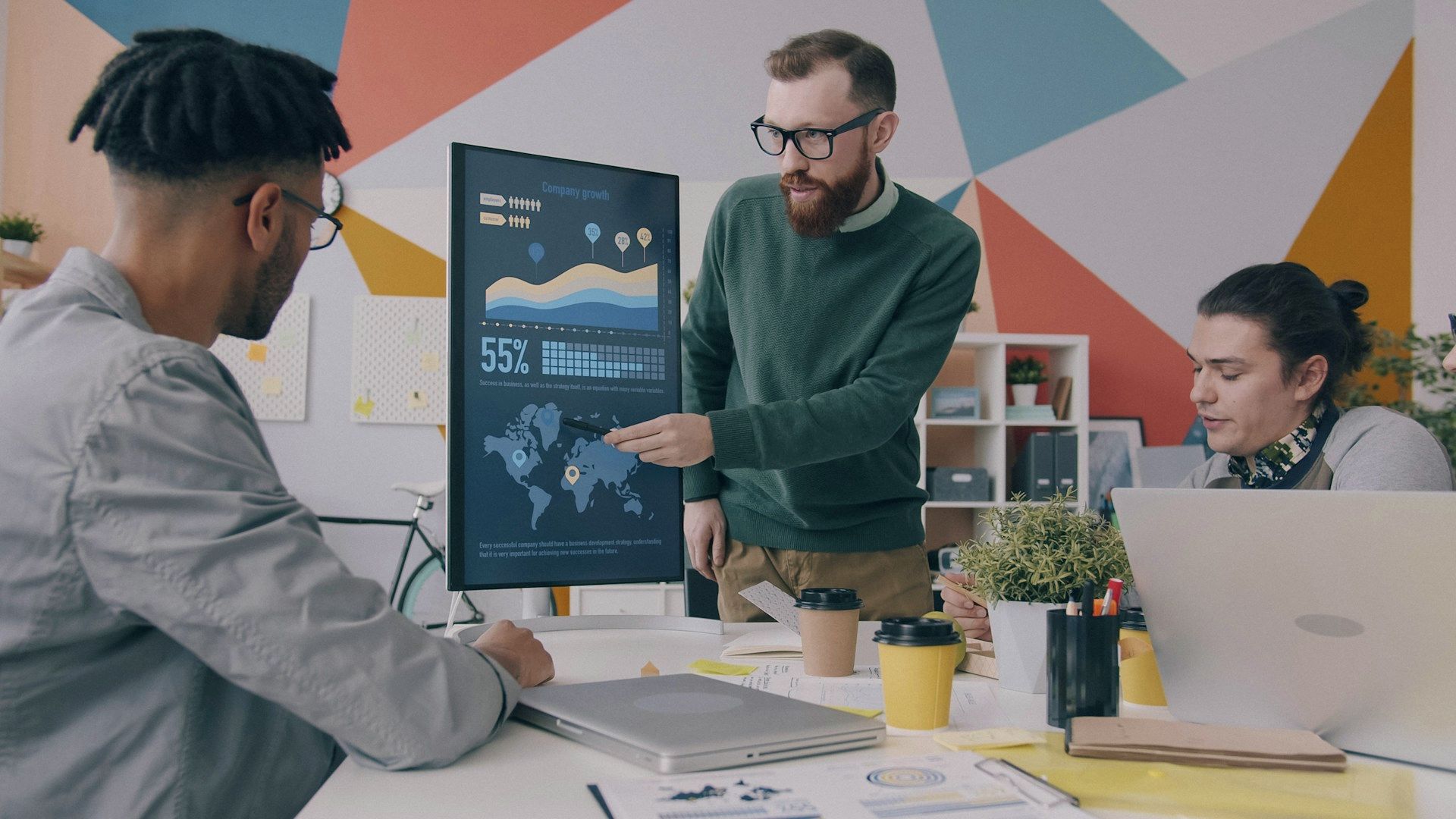 Colleagues reviewing a dashboard chart on a screen
