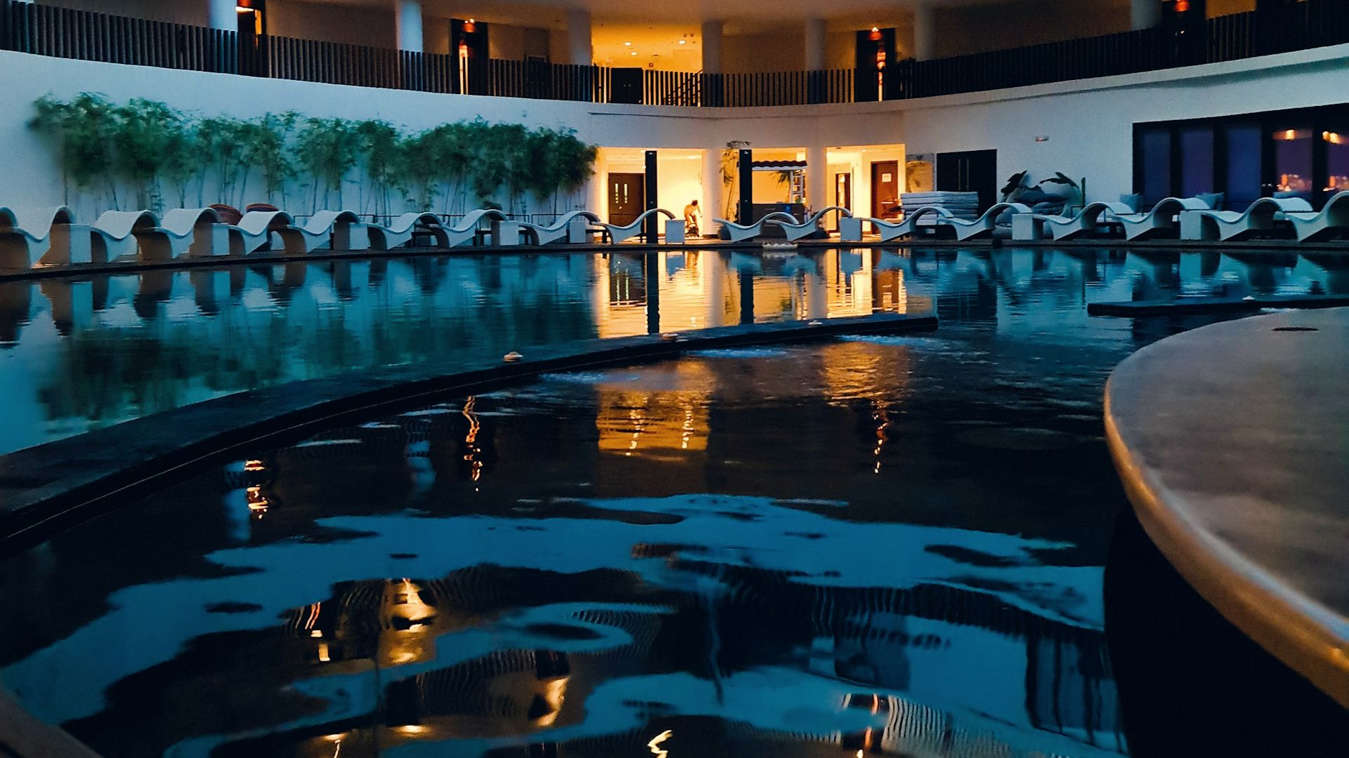 A resort courtyard and pool at dusk in Malay, Philippines